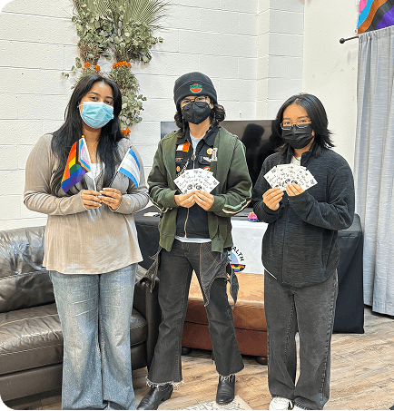 Three volunteers holding service items