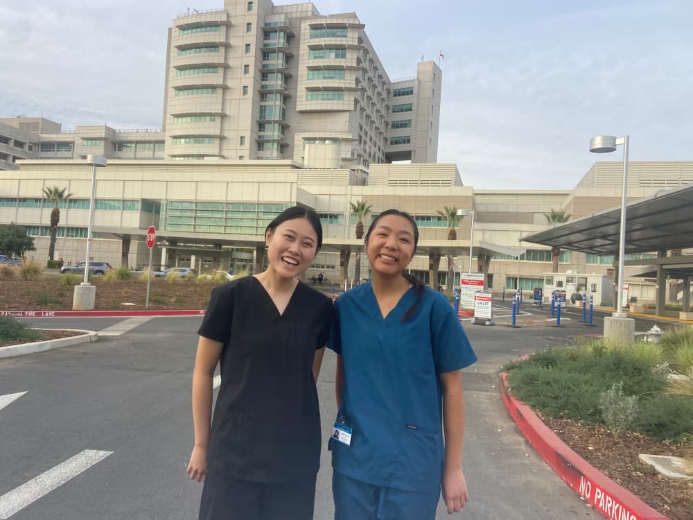 Two volunteers smiling